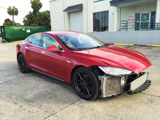 Tesla S med demontert front som viser kondenser på høyre side.